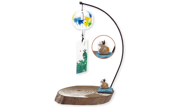 Here is a picture of the item. There is a thin curved part on the right end of a flat stump to which a wind chime is attached, and a small sitting cat doll at the base.